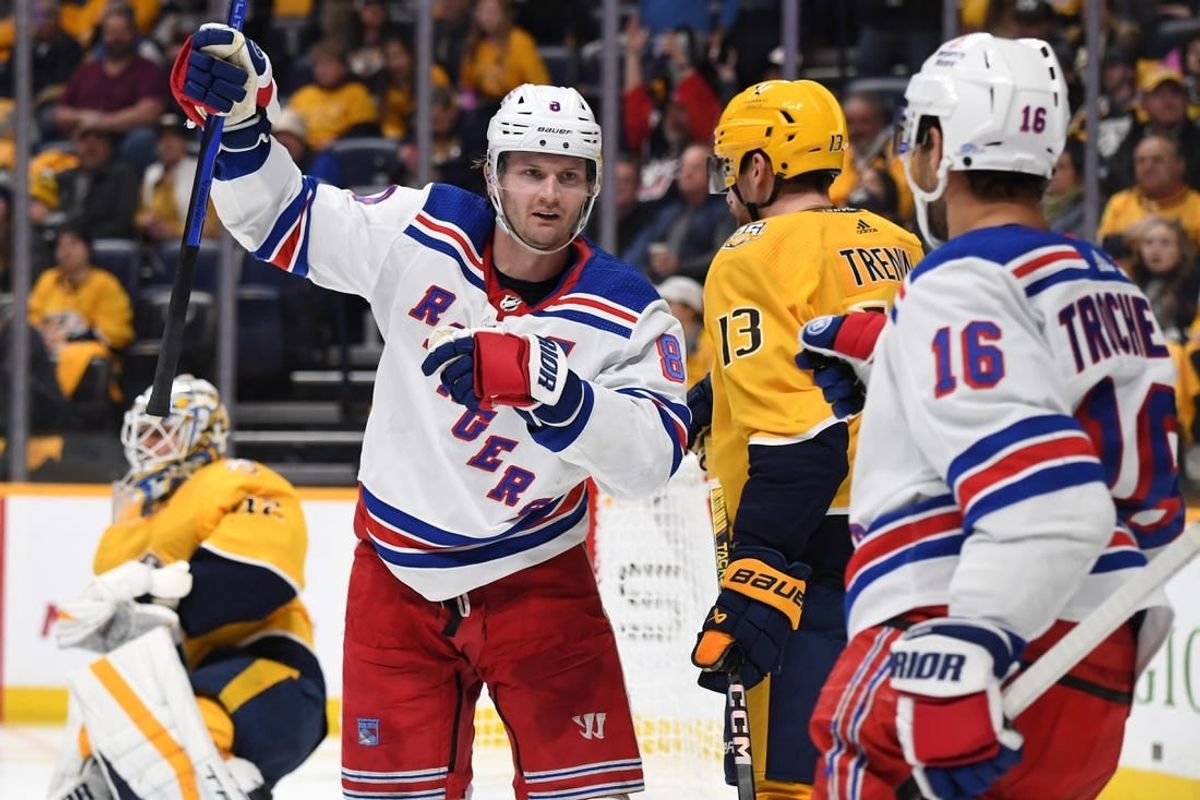 Dec 2, 2023; Nashville, Tennessee, USA; New York Rangers defenseman Jacob Trouba (8) celebrates after a goal against Nashville Predators goaltender Kevin Lankinen (32) during the second period at Bridgestone Arena.