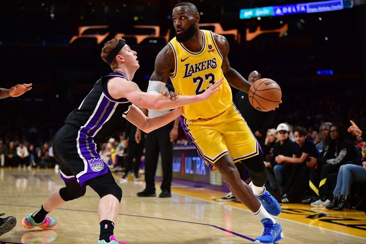 Mar 6, 2024; Los Angeles, California, USA;  Los Angeles Lakers forward LeBron James (23) moves the ball against Sacramento Kings guard Kevin Huerter (9) during the second half at Crypto.com Arena.