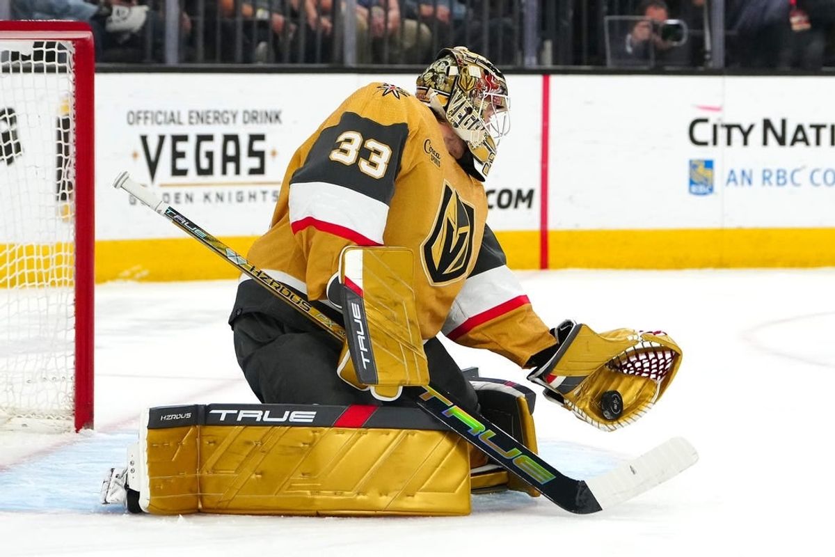 Apr 18, 2024; Las Vegas, Nevada, USA; Vegas Golden Knights goaltender Adin Hill (33) makes a glove save against the Anaheim Ducks during the first period at T-Mobile Arena.