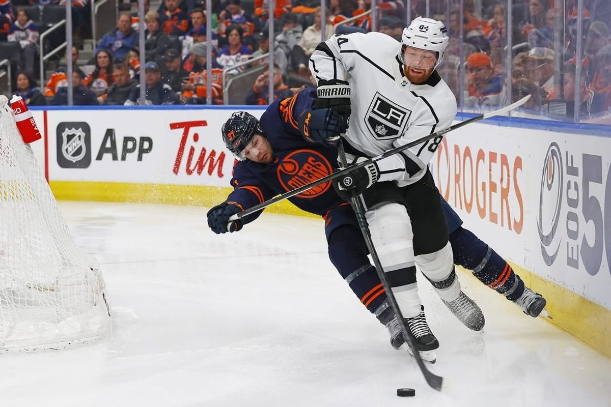 Mar 28, 2024; Edmonton, Alberta, CAN; Edmonton Oilers forward Warren Foegele (37) tries to knock Los Angeles Kings defensemen Vladislav Gavrikov (84) off the puck during the third period at Rogers Place.