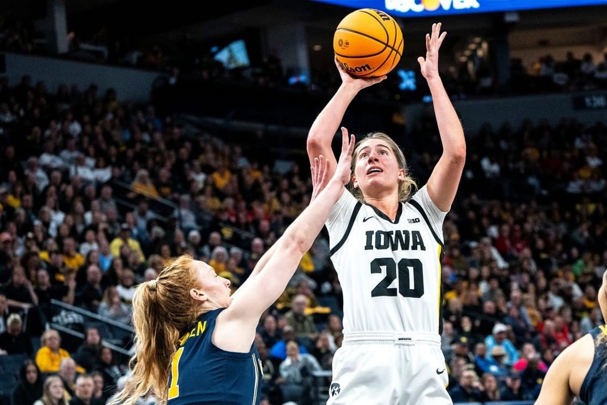 Iowa guard Kate Martin (20) attempts a shot against Michigan guard Lauren Hansen (1) during the Big Ten Tournament semifinals at the Target Center on Saturday, March 9, 2024, in Minneapolis, Minn.