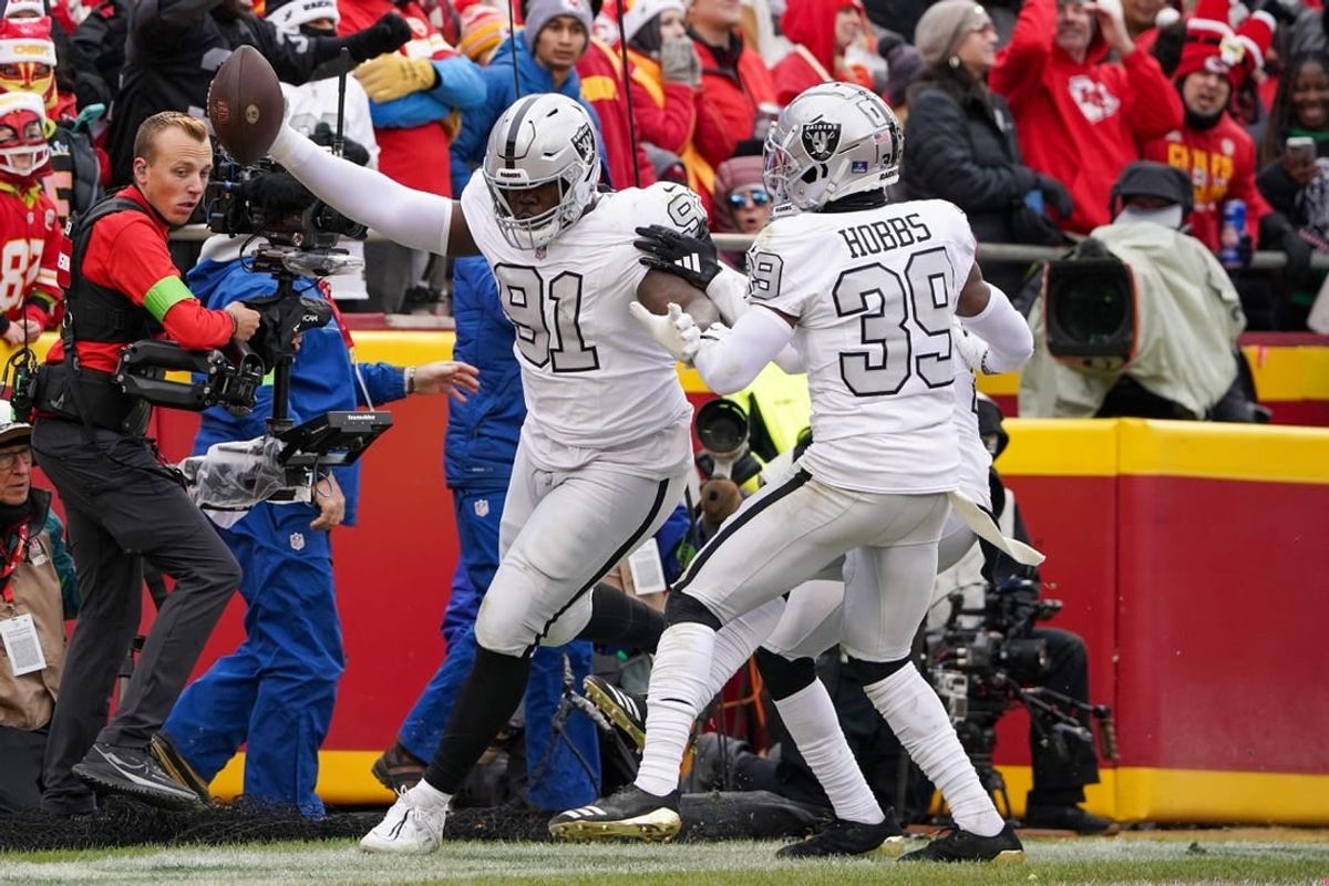 Dec 25, 2023; Kansas City, Missouri, USA; Las Vegas Raiders defensive tackle Bilal Nichols (91) scores against the Kansas City Chiefs after picking up a fumble during the first half at GEHA Field at Arrowhead Stadium.