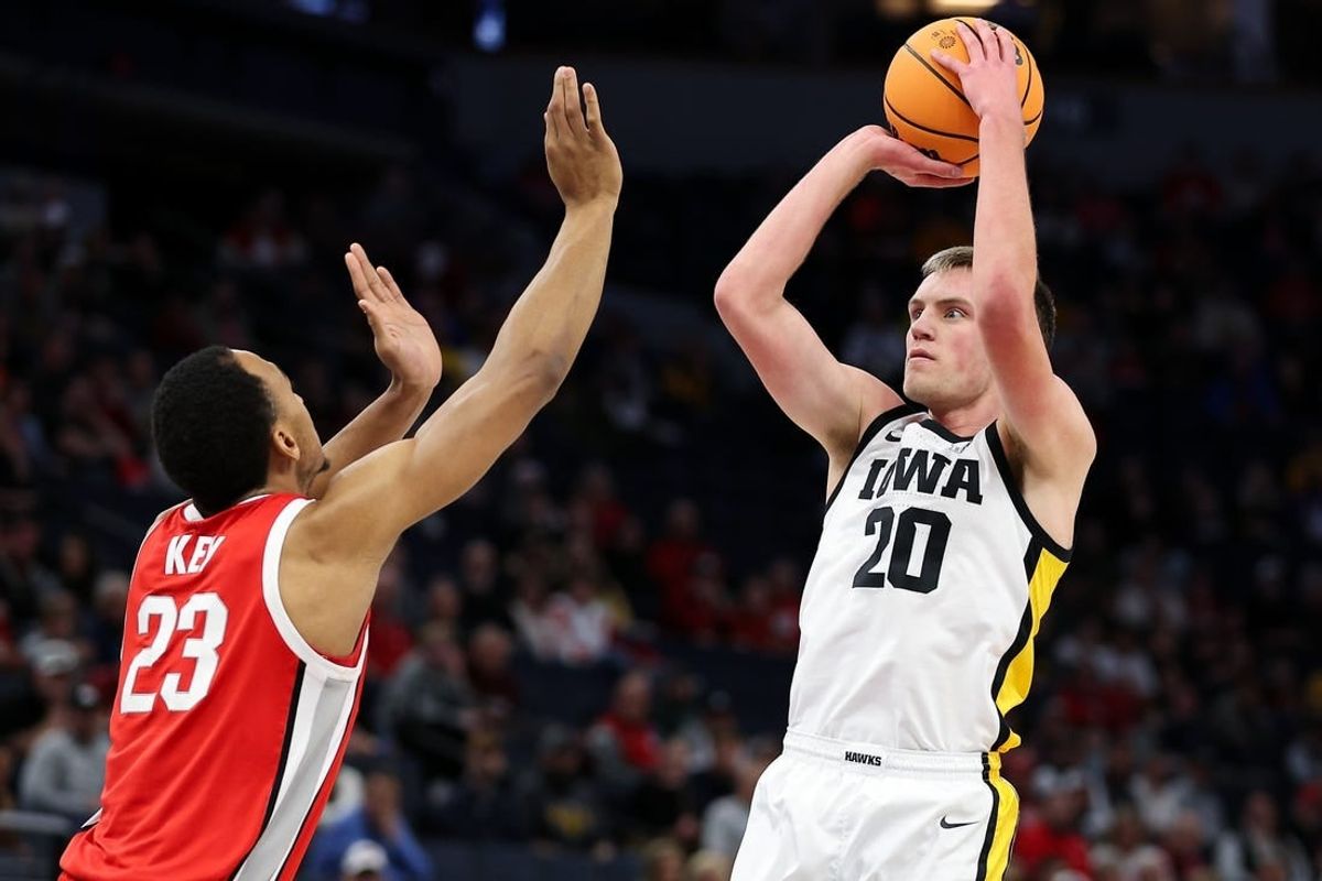 Mar 14, 2024; Minneapolis, MN, USA; Iowa Hawkeyes forward Payton Sandfort (20) shoots as Ohio State Buckeyes forward Zed Key (23) defends during the first half at Target Center.