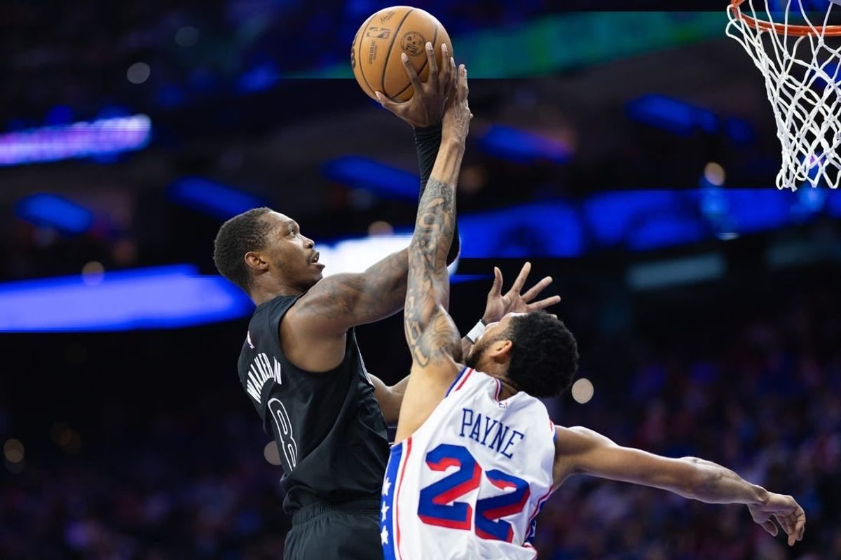 Apr 14, 2024; Philadelphia, Pennsylvania, USA; Philadelphia 76ers guard Cameron Payne (22) blocks the shot attempt of Brooklyn Nets guard Lonnie Walker IV (8) during the second quarter at Wells Fargo Center.