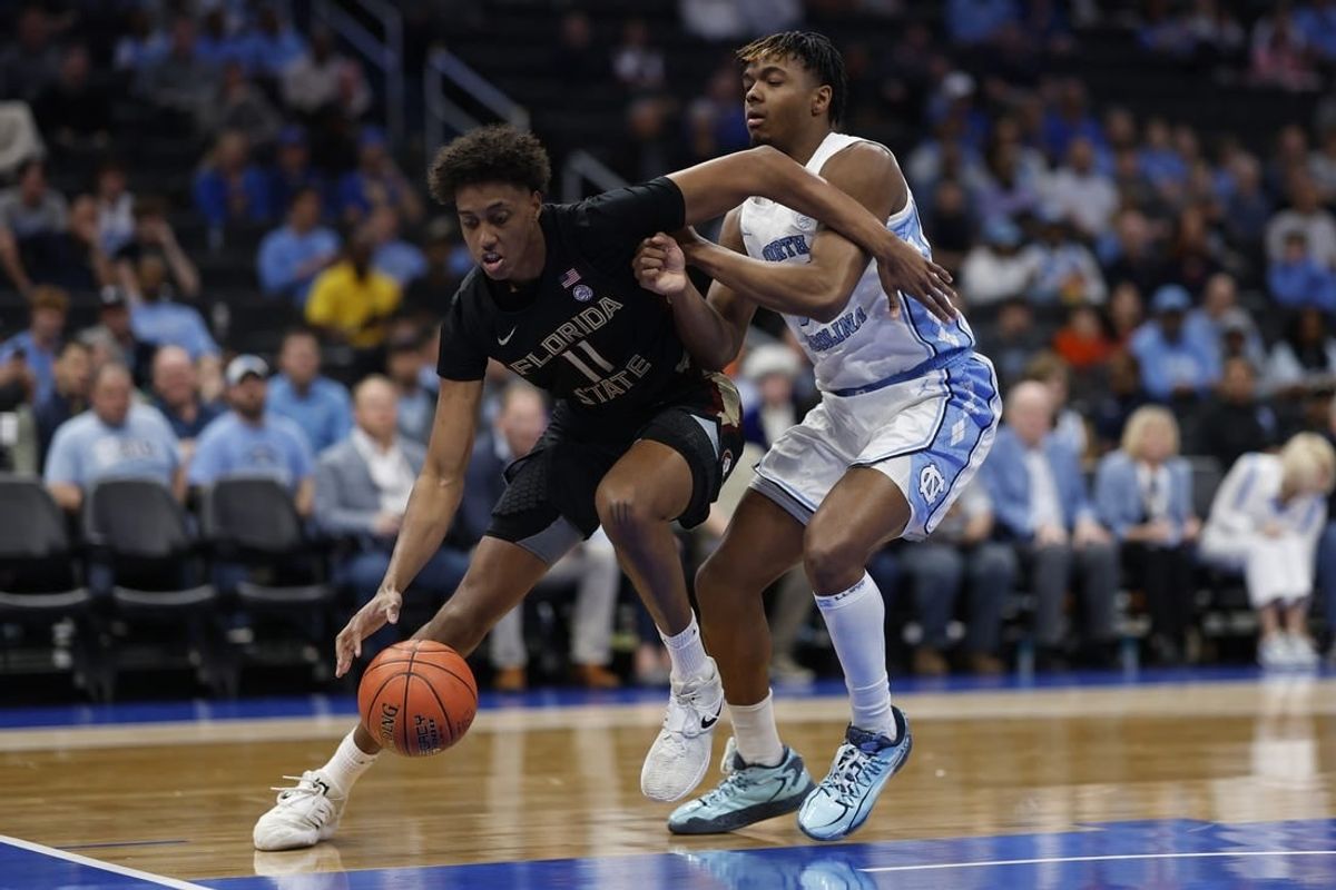 Mar 14, 2024; Washington, D.C., USA; Florida State forward Baba Miller (11) drives to the basket as North Carolina forward Harrison Ingram (55) defends in the first half at Capital One Arena.