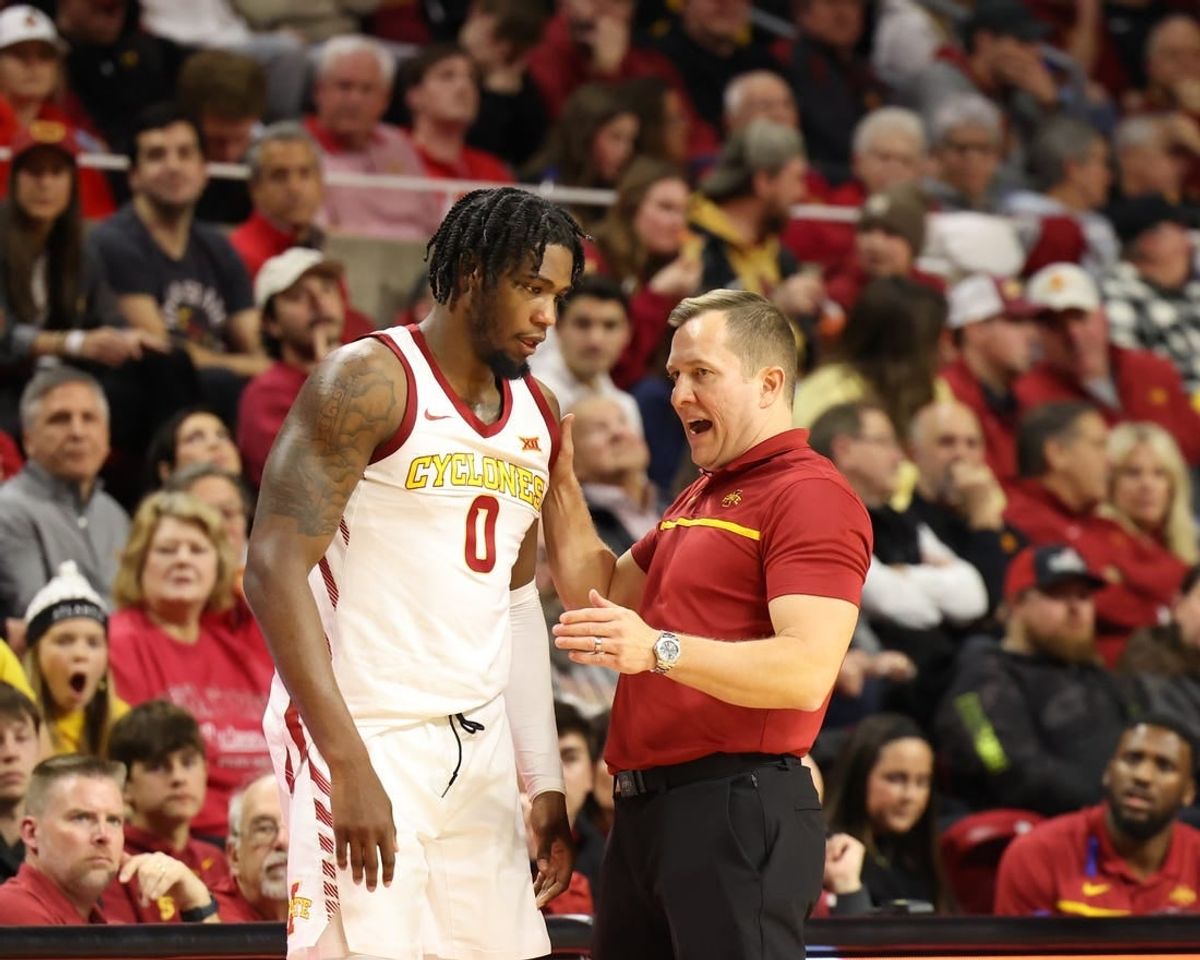 Jan 9, 2024; Ames, Iowa, USA; Iowa State Cyclones head coach TJ Otzelberger talks to Iowa State Cyclones forward Tre King (0) during a timeout during their game with the Houston Cougars at James H. Hilton Coliseum.