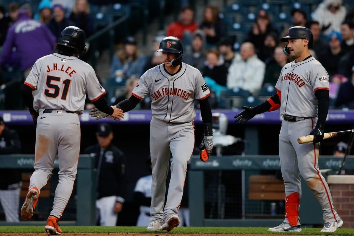 May 7, 2024; Denver, Colorado, USA; San Francisco Giants shortstop Nick Ahmed (16) celebrates with center fielder Jung Hoo Lee (51) ahead of left fielder Michael Conforto (8) in the fourth inning against the Colorado Rockies at Coors Field.