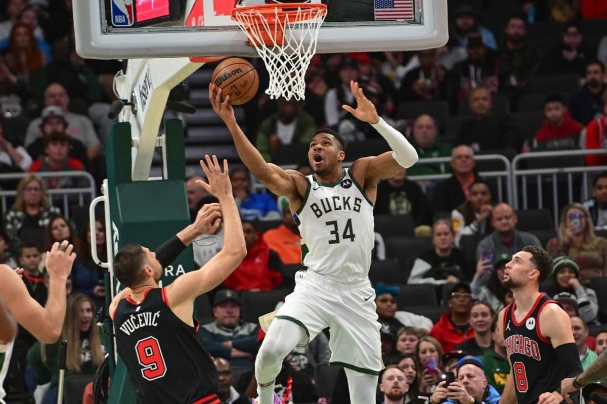 Nov 13, 2023; Milwaukee, Wisconsin, USA; Milwaukee Bucks forward Giannis Antetokounmpo (34) takes a shot against Chicago Bulls center Nikola Vucevic (9) in the first quarter at Fiserv Forum.