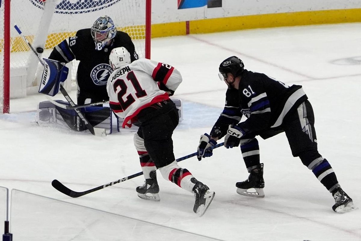 Feb 19, 2024; Tampa, Florida, USA; Ottawa Senators right wing Mathieu Joseph (21) scores against Tampa Bay Lightning goaltender Andrei Vasilevskiy (88) during the first period at Amalie Arena.