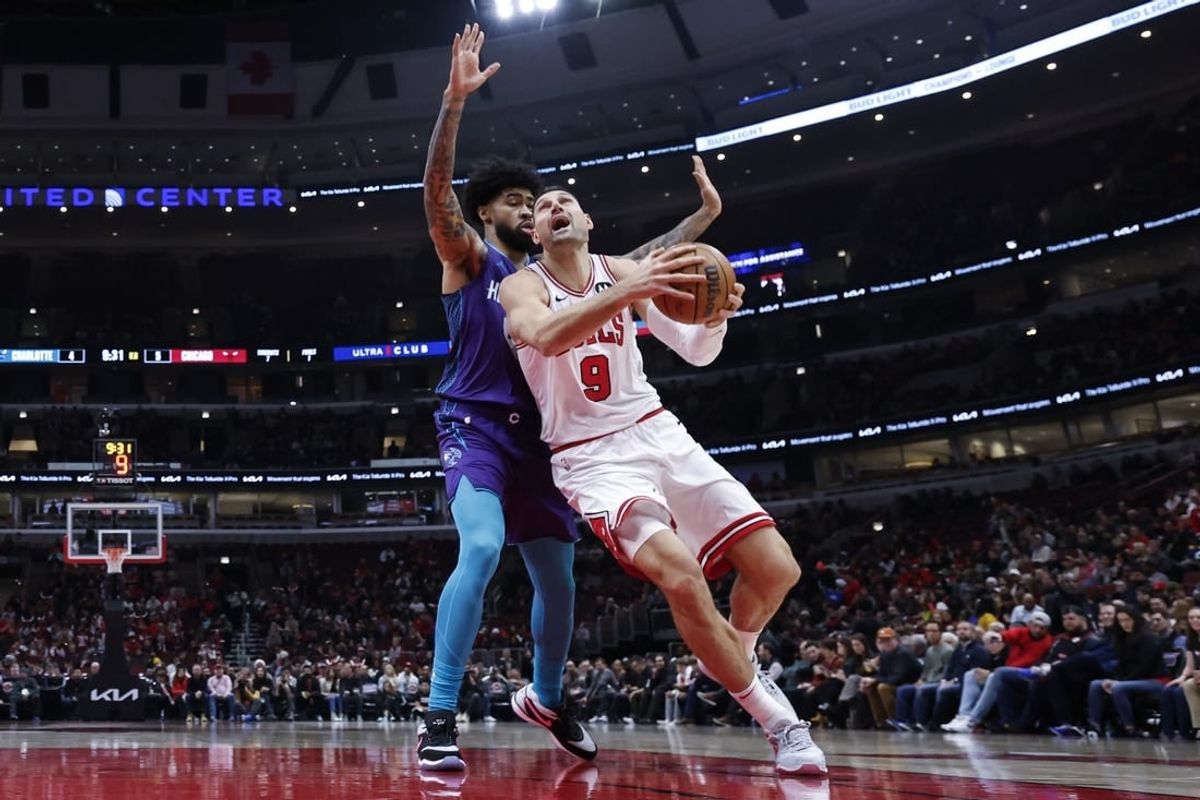 Dec 6, 2023; Chicago, Illinois, USA; Chicago Bulls center Nikola Vucevic (9) drives to the basket against Charlotte Hornets center Nick Richards (4) during the first half at United Center.