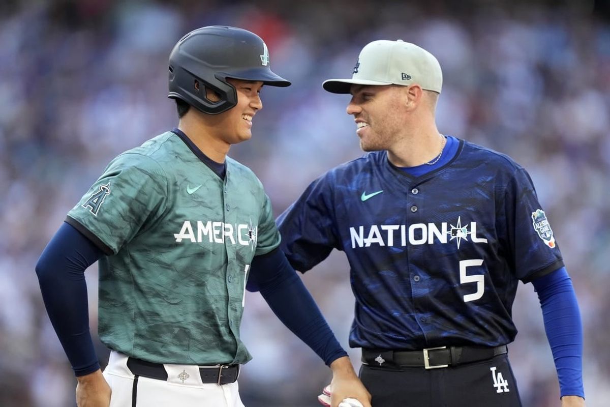 Jul 11, 2023; Seattle, Washington, USA; American League designated hitter/pitcher  Shohei Ohtani  of the Los Angeles Angels of Anaheim (17) reacts with National League first baseman  Freddie Freeman  of the Los Angeles Dodgers (5) during the fifth inning at T-Mobile Park.