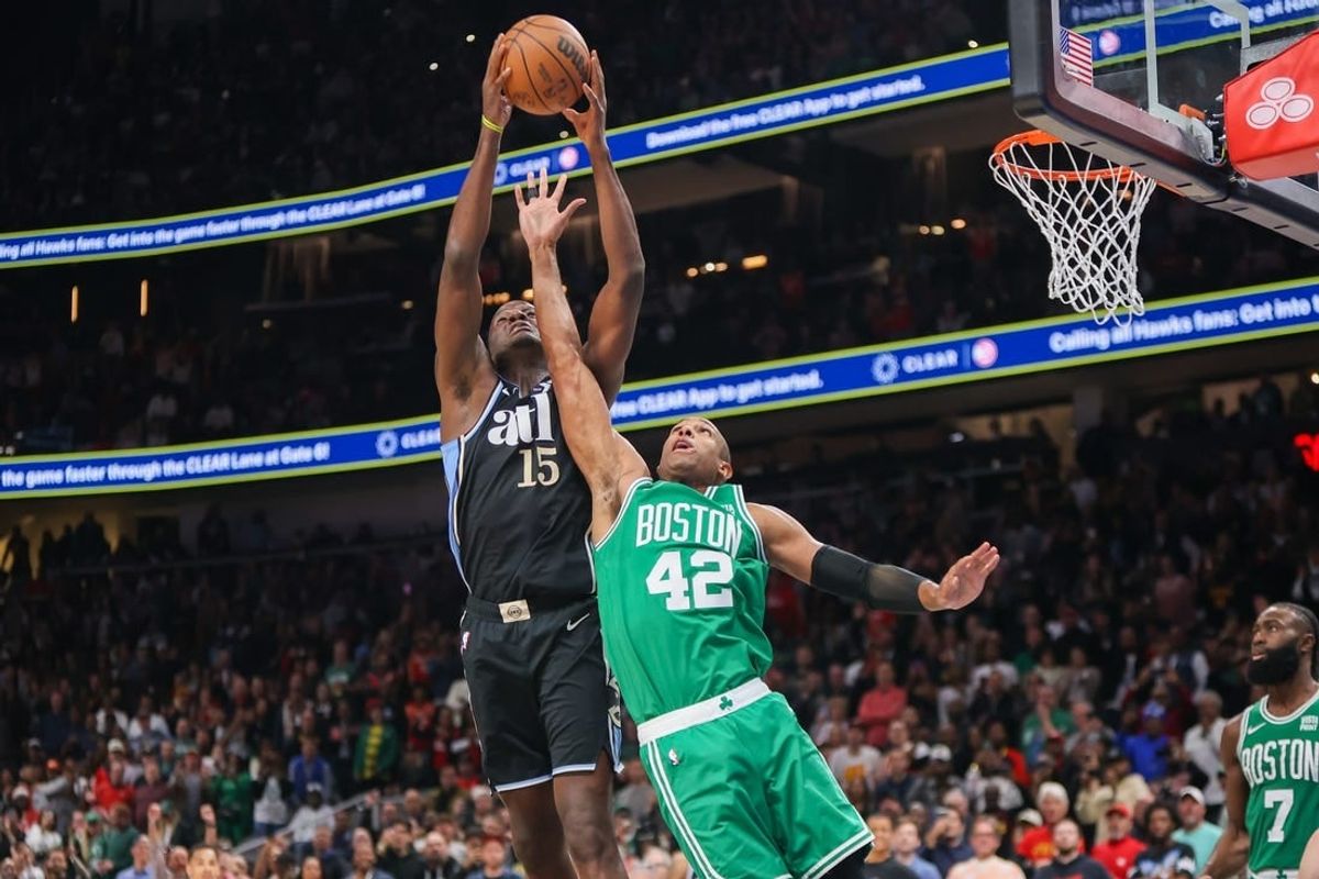 Mar 25, 2024; Atlanta, Georgia, USA; Atlanta Hawks center Clint Capela (15) grabs a rebound over Boston Celtics center Al Horford (42) in the second half at State Farm Arena.