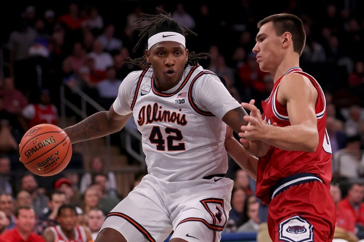 Dec 5, 2023; New York, New York, USA; Illinois Fighting Illini forward Dain Dainja (42) controls the ball against Florida Atlantic Owls center Vladislav Goldin (50) during the first half at Madison Square Garden.