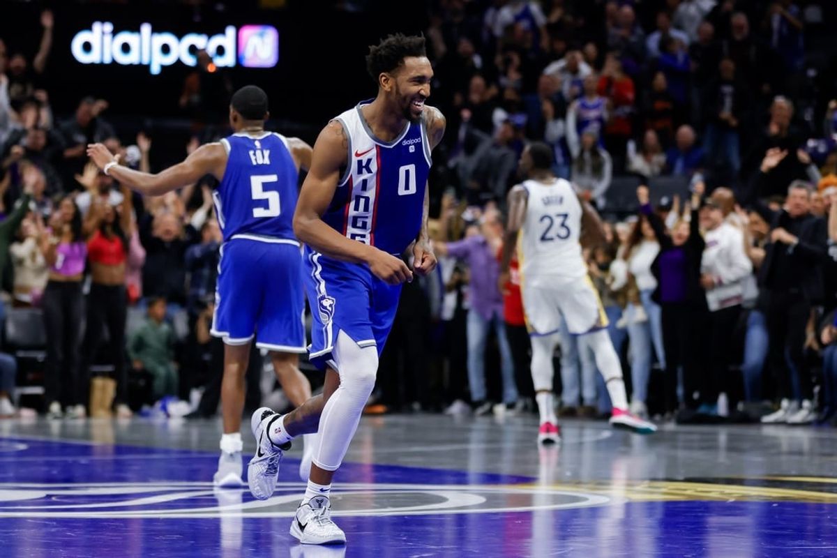 Nov 28, 2023; Sacramento, California, USA; Sacramento Kings guard Malik Monk (0) smiles after scoring a basket during the fourth quarter against the Golden State Warriors at Golden 1 Center.