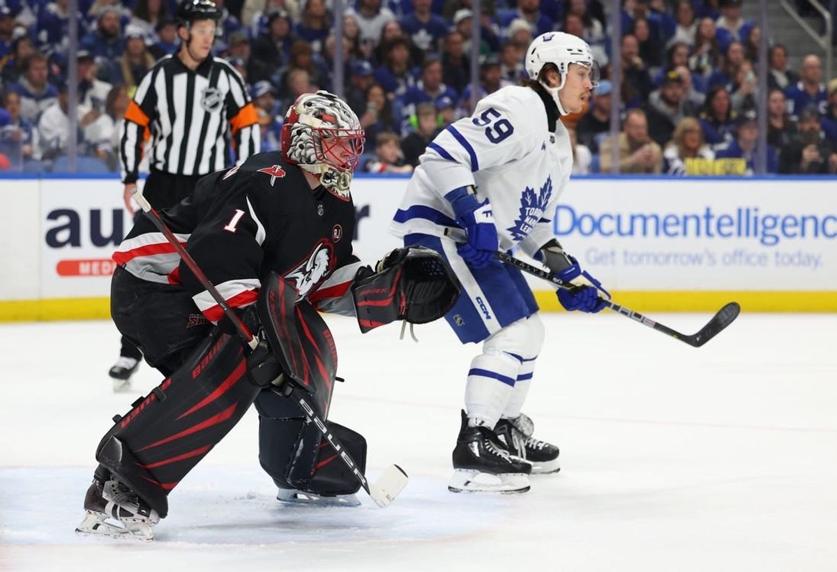Mar 30, 2024; Buffalo, New York, USA;  Buffalo Sabres goaltender Ukko-Pekka Luukkonen (1) and Toronto Maple Leafs left wing Tyler Bertuzzi (59) look for the puck during the first period at KeyBank Center.