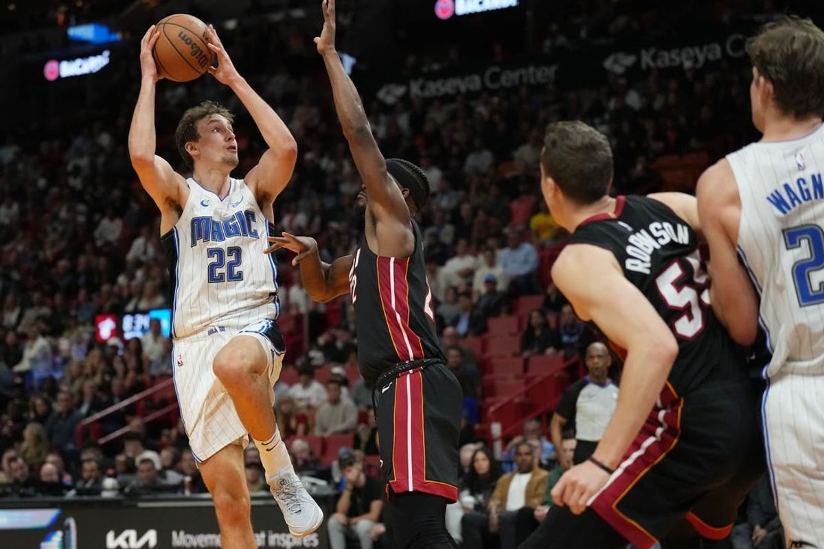Feb 6, 2024; Miami, Florida, USA;  Orlando Magic forward Franz Wagner (22) goes up for a shot over Miami Heat forward Jimmy Butler (22) during the second half at Kaseya Center.