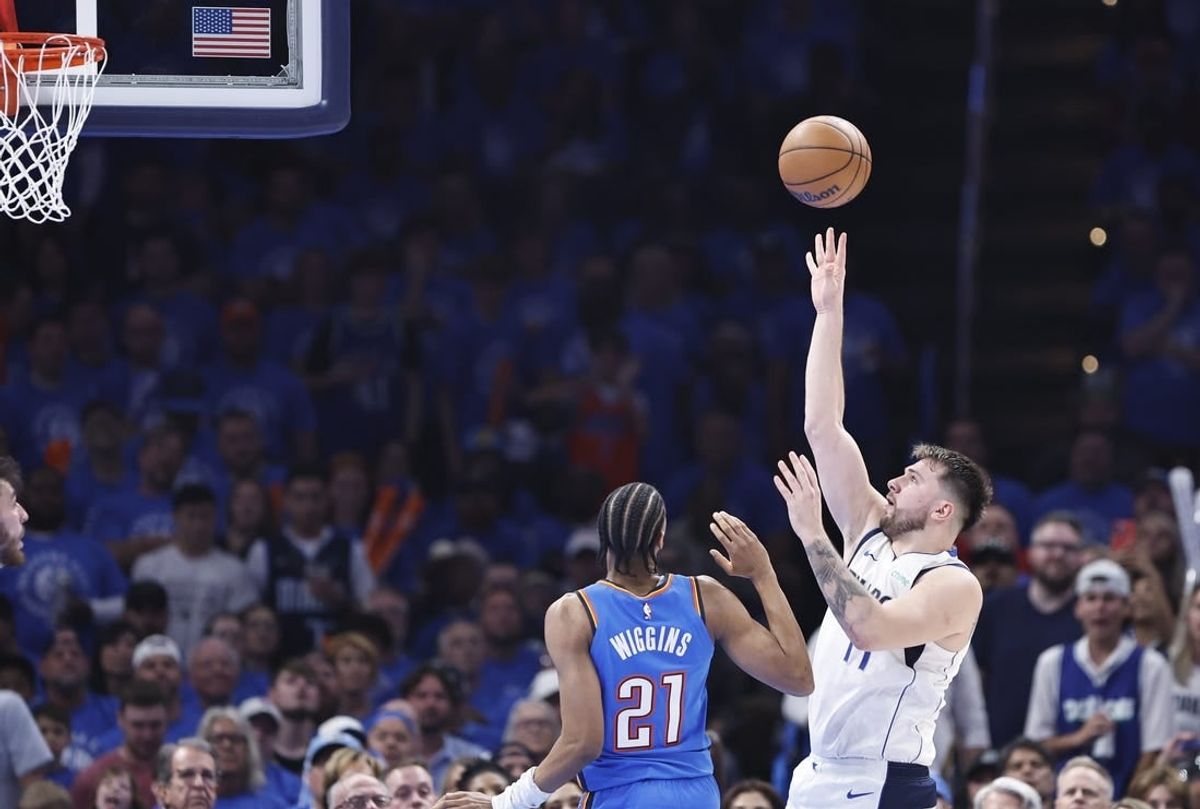 May 9, 2024; Oklahoma City, Oklahoma, USA; Dallas Mavericks guard Luka Doncic (77) shoots beside Oklahoma City Thunder guard Aaron Wiggins (21) during the second quarter of game two of the second round for the 2024 NBA playoffs at Paycom Center.
