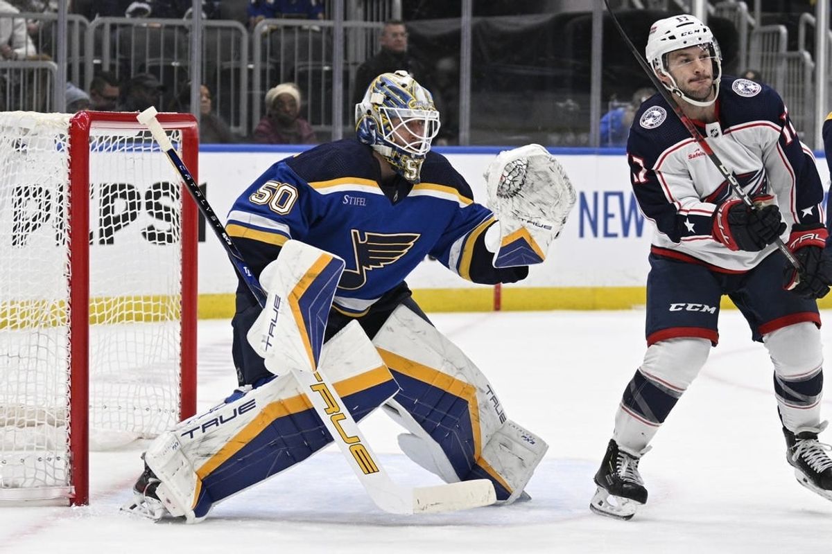 Jan 30, 2024; St. Louis, Missouri, USA; St. Louis Blues goaltender Jordan Binnington (50) defends the net from Columbus Blue Jackets right wing Justin Danforth (17) during the first period at Enterprise Center.