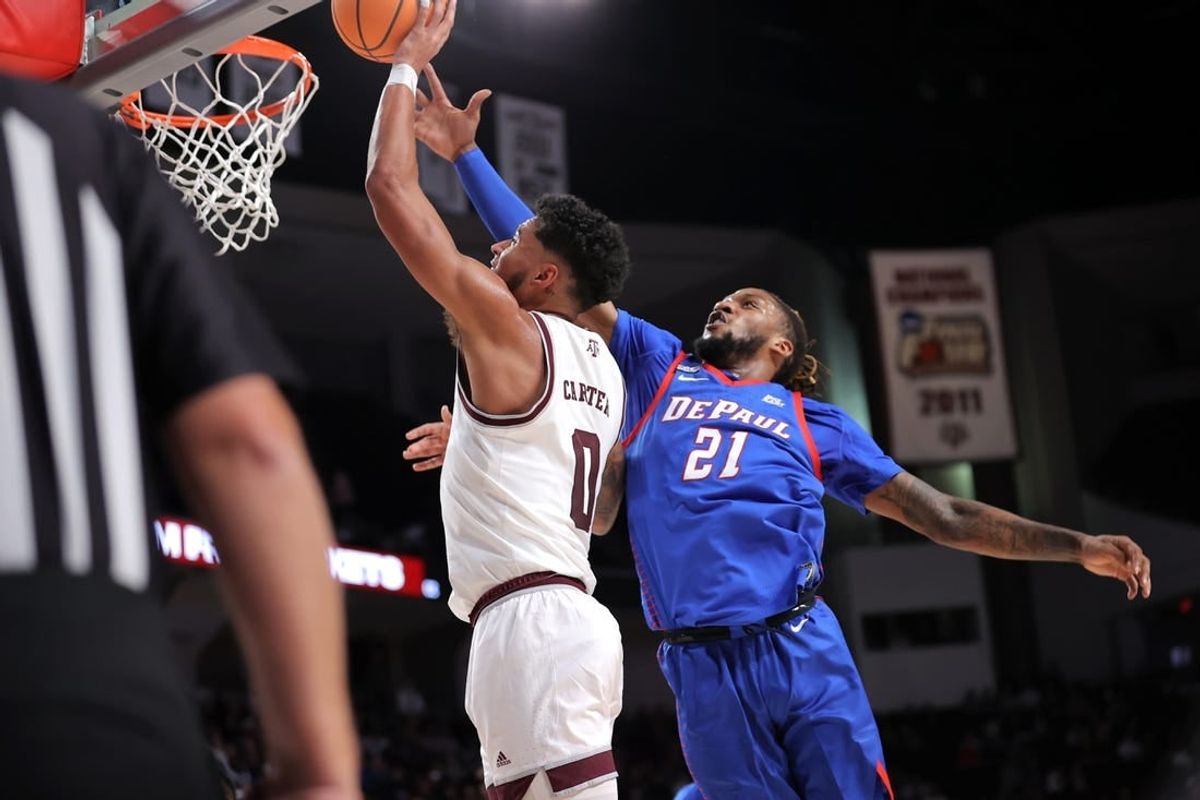 Dec 6, 2023; College Station, Texas, USA; Texas A&M Aggies guard Jace Carter (0) shoots an inside shot against DePaul Blue Demons forward Da'Sean Nelson (21) during the first half at Reed Arena.