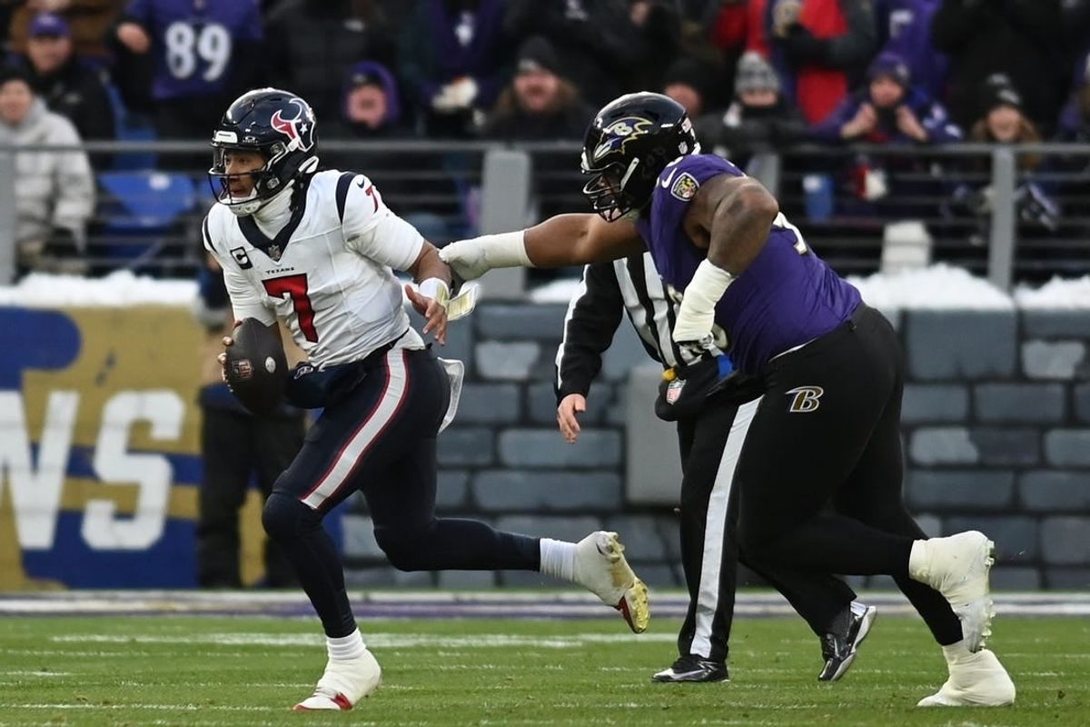 Jan 20, 2024; Baltimore, MD, USA; Houston Texans quarterback C.J. Stroud (7) runs the ball against Baltimore Ravens defensive tackle Justin Madubuike (92) during the first quarter of a 2024 AFC divisional round game at M&T Bank Stadium.