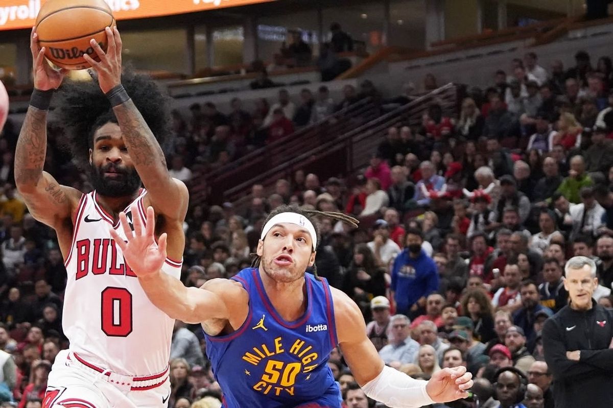 Dec 12, 2023; Chicago, Illinois, USA; Denver Nuggets forward Aaron Gordon (50) defends Chicago Bulls guard Coby White (0) during the first half at United Center.
