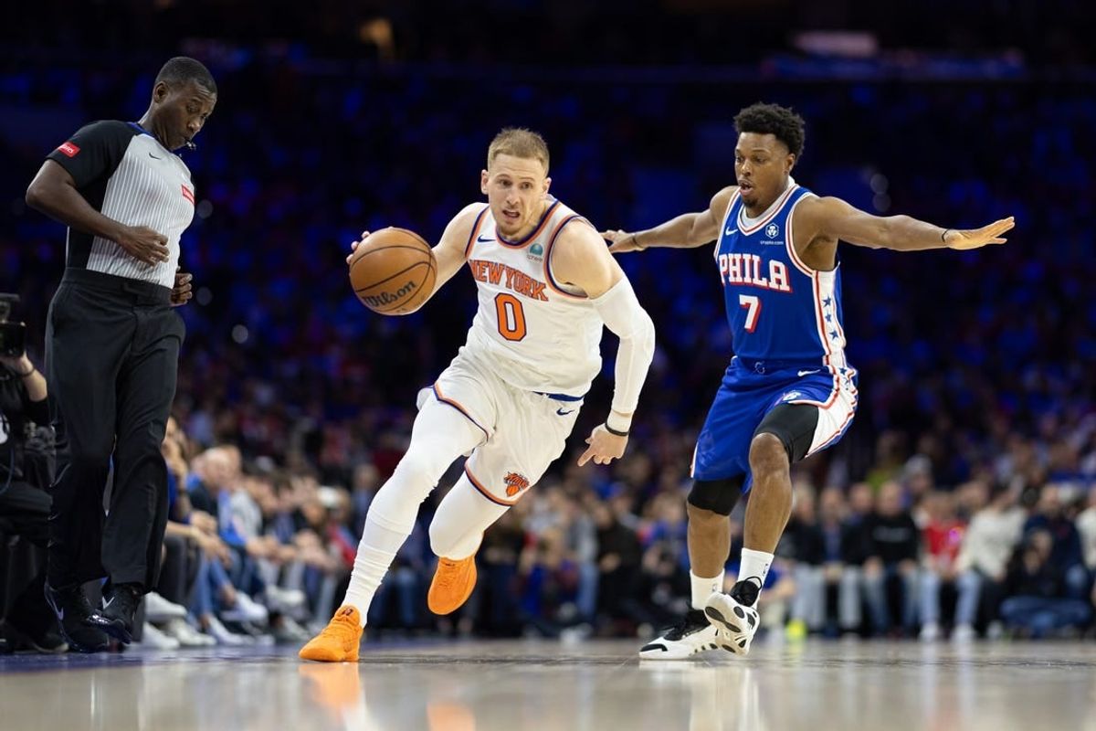 Apr 25, 2024; Philadelphia, Pennsylvania, USA; New York Knicks guard Donte DiVincenzo (0) dribbles past Philadelphia 76ers guard Kyle Lowry (7) during the first quarter of game three of the first round for the 2024 NBA playoffs at Wells Fargo Center.