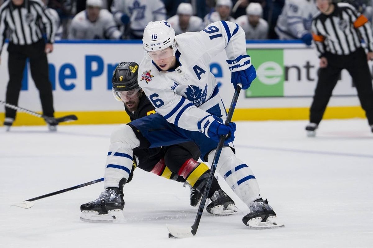 Jan 20, 2024; Vancouver, British Columbia, CAN; Vancouver Canucks forward Conor Garland (8) checks Toronto Maple Leafs forward Mitchell Marner (16) in the second period at Rogers Arena.