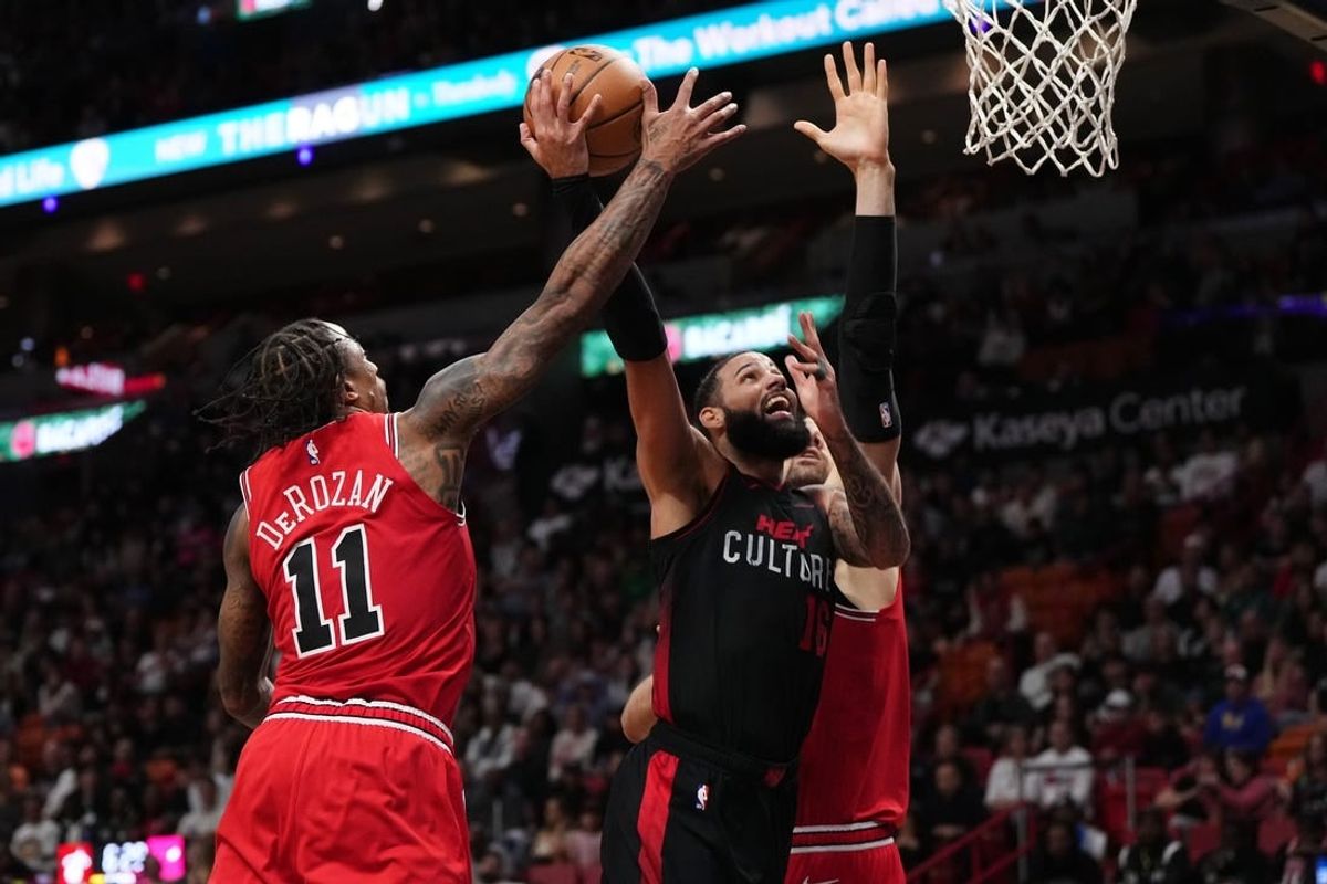 Dec 16, 2023; Miami, Florida, USA; Chicago Bulls forward DeMar DeRozan (11) blocks the shot of Miami Heat forward Caleb Martin (16) during the second half at Kaseya Center.