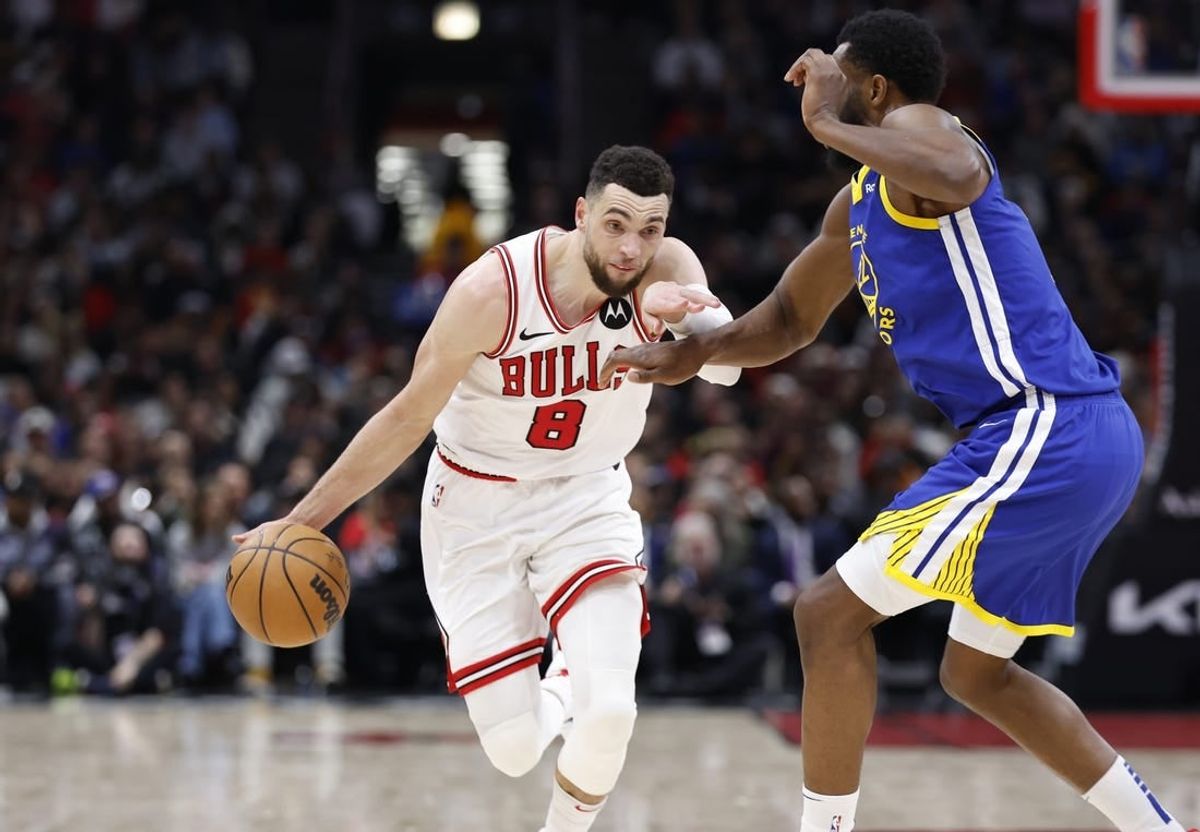 Jan 12, 2024; Chicago, Illinois, USA; Chicago Bulls guard Zach LaVine (8) drives against Golden State Warriors forward Andrew Wiggins (22) during the second half at United Center.