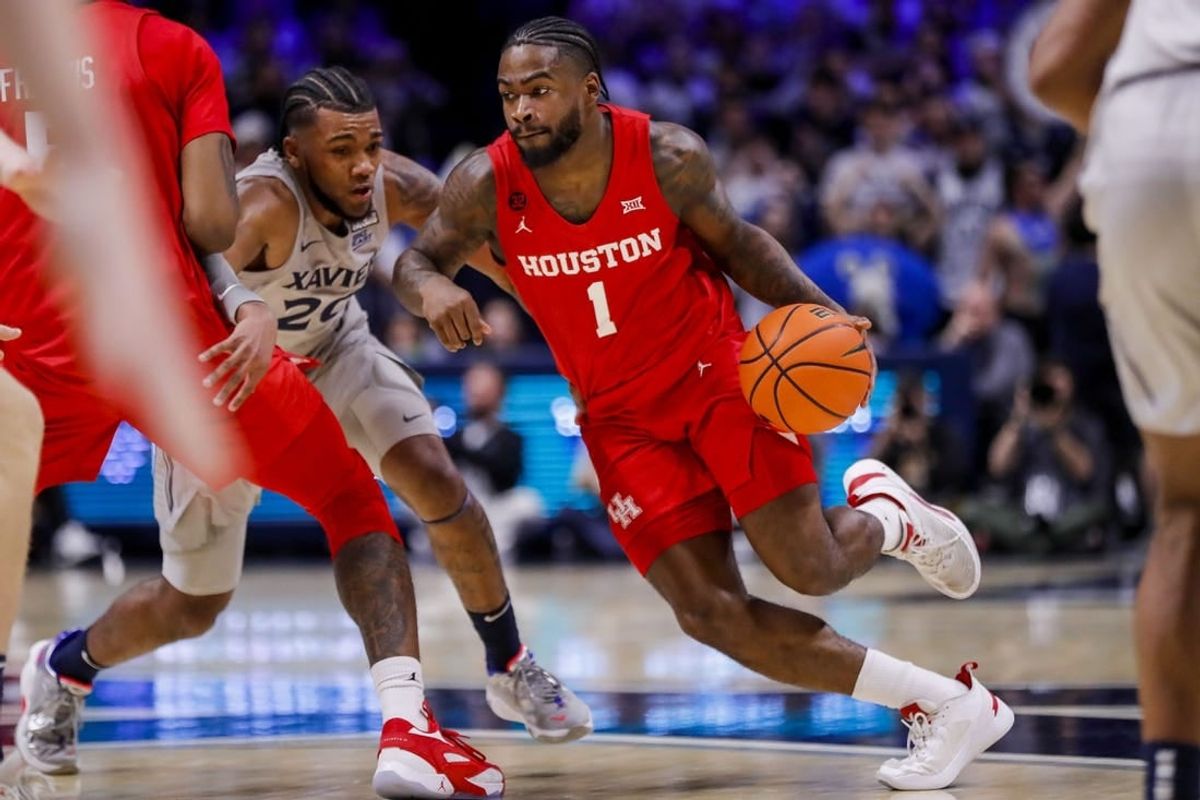 Dec 1, 2023; Cincinnati, Ohio, USA; Houston Cougars guard Jamal Shead (1) dribbles against Xavier Musketeers guard Dayvion McKnight (20) in the first half at Cintas Center.