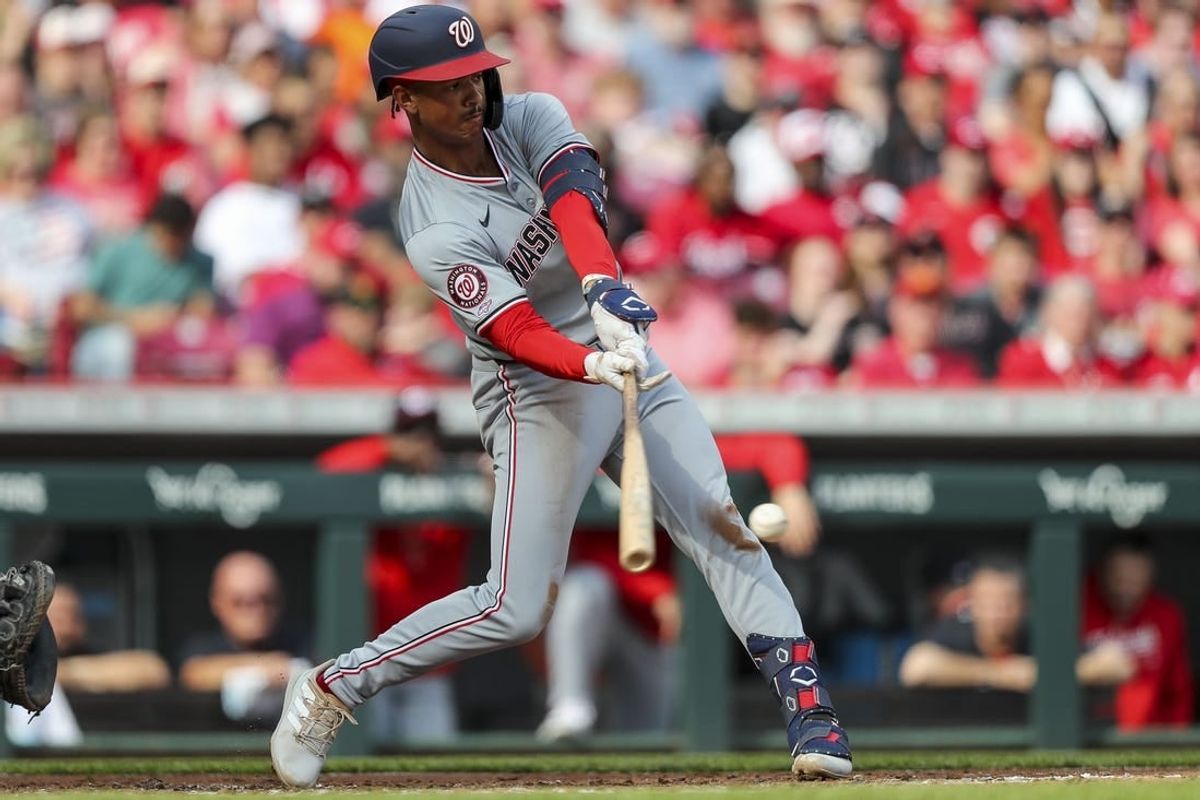 Mar 30, 2024; Cincinnati, Ohio, USA; Washington Nationals third baseman Trey Lipscomb (38) hits a single against the Cincinnati Reds in the third inning at Great American Ball Park.