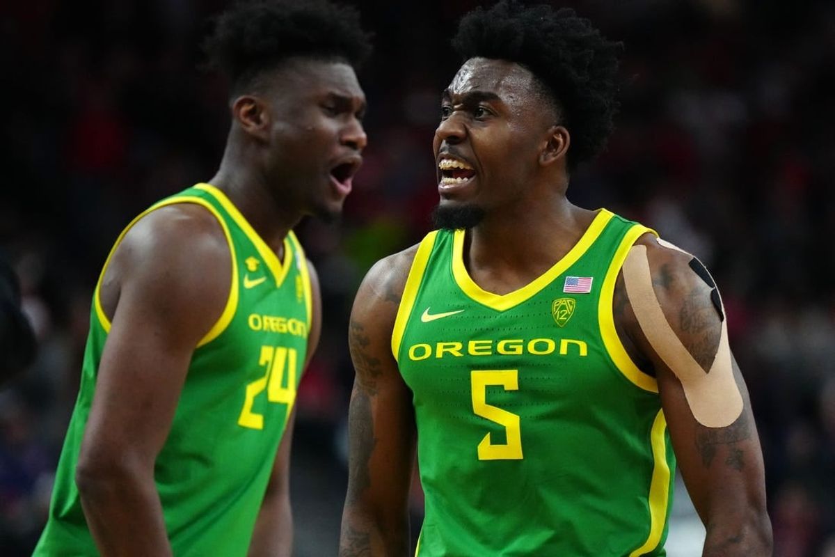 Mar 15, 2024; Las Vegas, NV, USA; Oregon Ducks guard Jermaine Couisnard (5) and forward Mahamadou Diawara (24) celebrate against the Arizona Wildcats in the second half at T-Mobile Arena.