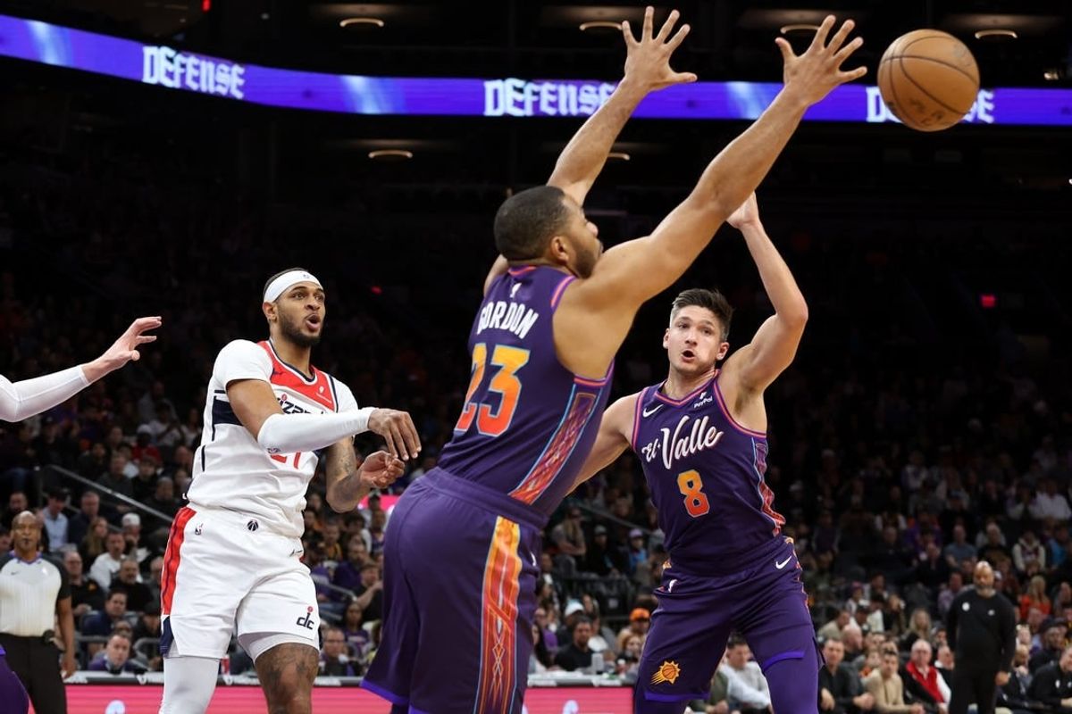 Dec 17, 2023; Phoenix, Arizona, USA; Phoenix Suns guard Eric Gordon (23) gets a steel from Washington Wizards center Daniel Gafford (21) during the first quarter at Footprint Center.