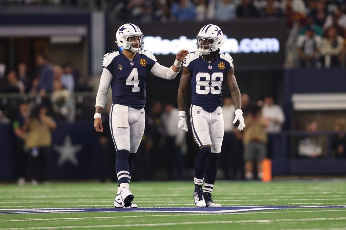 Nov 23, 2023; Arlington, Texas, USA; Dallas Cowboys wide receiver CeeDee Lamb (88) and quarterback Dak Prescott (4) talk during the game against the Washington Commanders at AT&T Stadium.