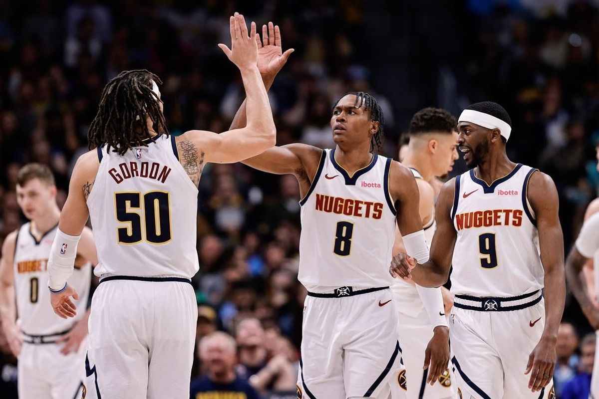 Apr 2, 2024; Denver, Colorado, USA; Denver Nuggets forward Peyton Watson (8) reacts with forward Aaron Gordon (50) ahead of forward Justin Holiday (9) in the fourth quarter against the San Antonio Spurs at Ball Arena.