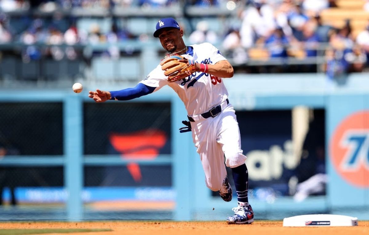 Mar 28, 2024; Los Angeles, California, USA; Los Angeles Dodgers outfielder Mookie Betts (50) throws to first for an out during the third inning of an opening day game against the St. Louis Cardinals at Dodger Stadium.