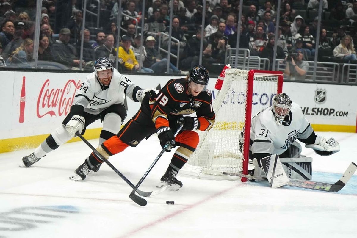 Apr 13, 2024; Los Angeles, California, USA; Anaheim Ducks right wing Troy Terry (19) skates with the puck against LA Kings defenseman Vladislav Gavrikov (84) and goaltender David Rittich (31) in the first period at Crypto.com Arena.