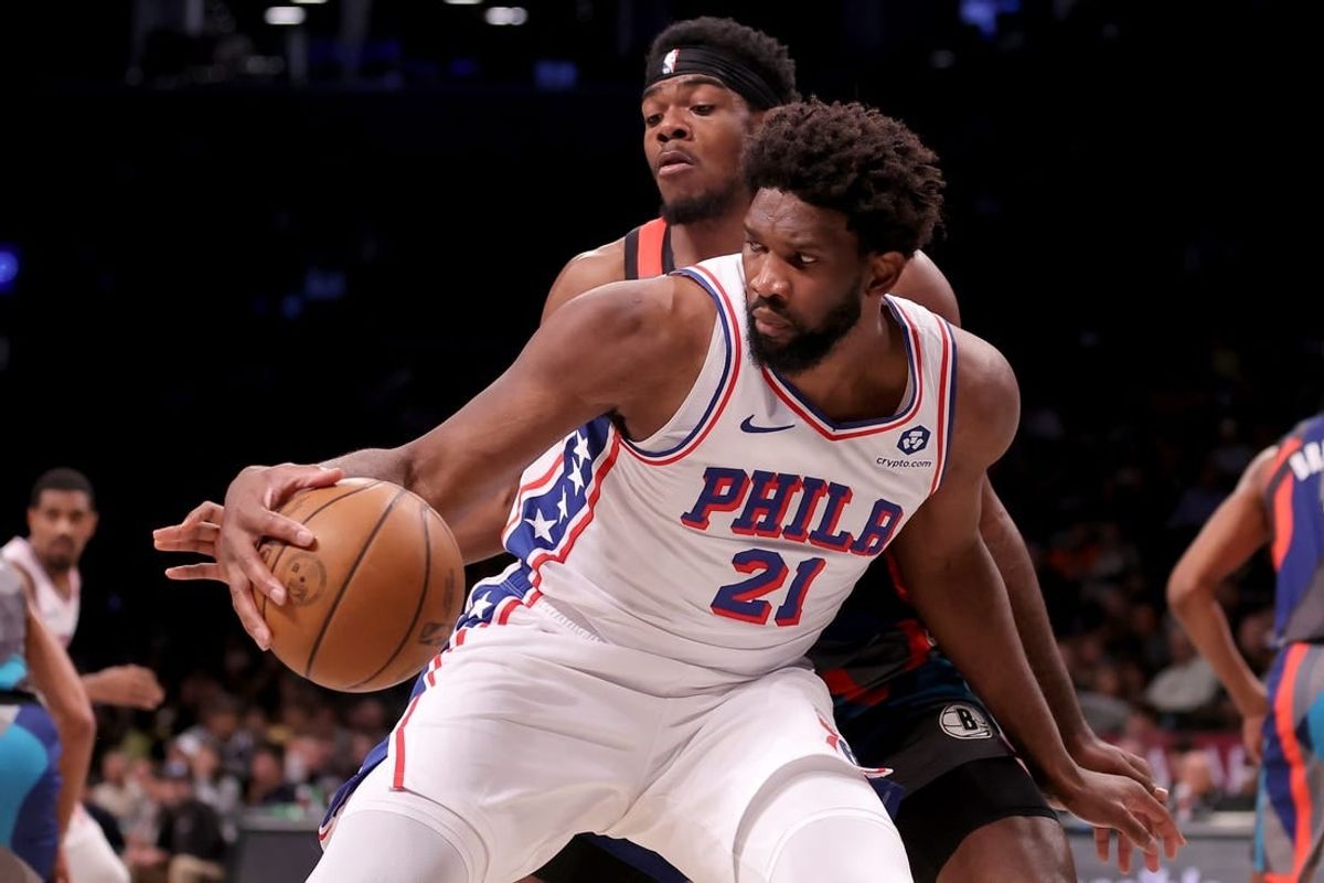 Nov 19, 2023; Brooklyn, New York, USA; Philadelphia 76ers center Joel Embiid (21) controls the ball against Brooklyn Nets center Day'Ron Sharpe (20) during the second quarter at Barclays Center.