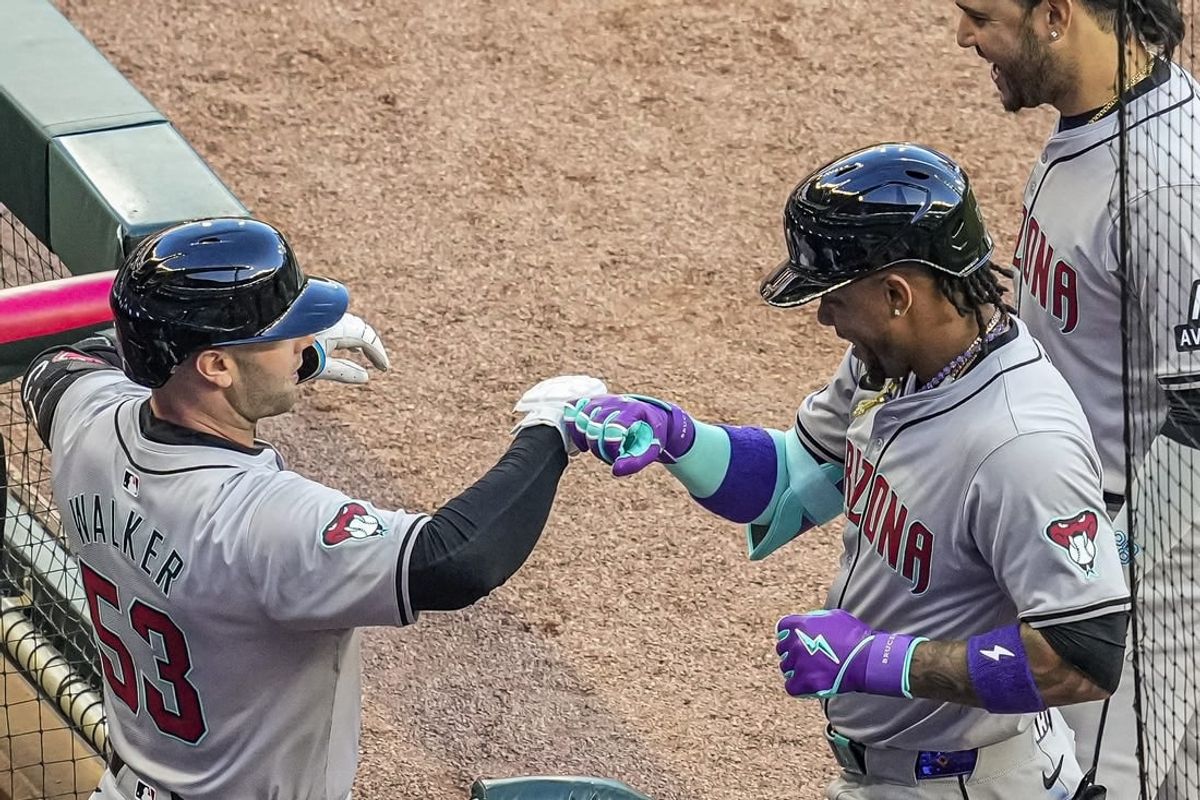 Apr 5, 2024; Cumberland, Georgia, USA; Arizona Diamondbacks second baseman Ketel Marte (4) reacts with first baseman Christian Walker (53) after hitting a lead off home run against the Atlanta Braves during the first inning at Truist Park.
