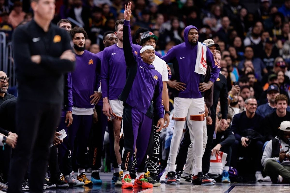 Mar 27, 2024; Denver, Colorado, USA; Phoenix Suns guard Isaiah Thomas (4) gestures from the bench in the fourth quarter against the Denver Nuggets at Ball Arena.