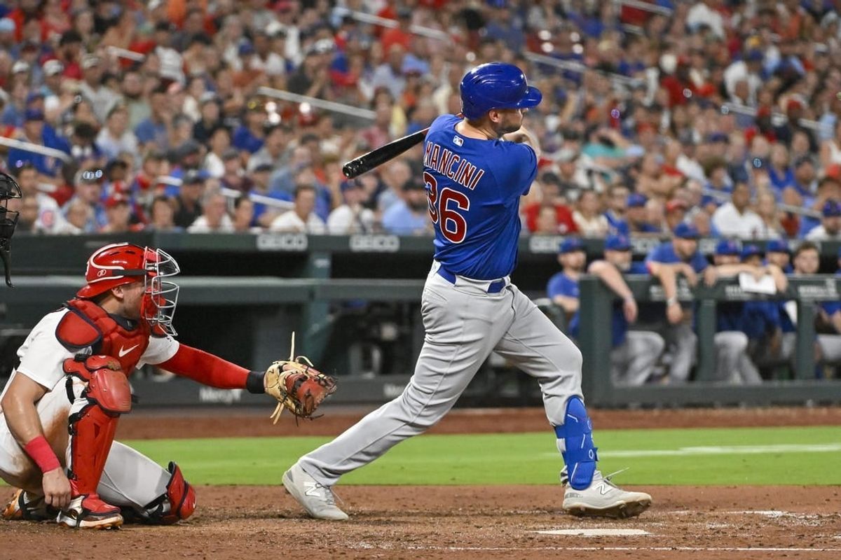 Jul 28, 2023; St. Louis, Missouri, USA;  Chicago Cubs first baseman Trey Mancini (36) hits a one run single against the St. Louis Cardinals during the sixth inning at Busch Stadium.