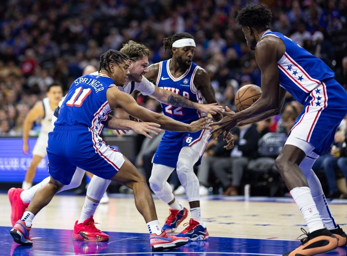 Feb 5, 2024; Philadelphia, Pennsylvania, USA; Dallas Mavericks guard Luka Doncic (77) and Philadelphia 76ers guard Jaden Springer (11) and guard Patrick Beverley (22) chase a loose ball during the second quarter at Wells Fargo Center.