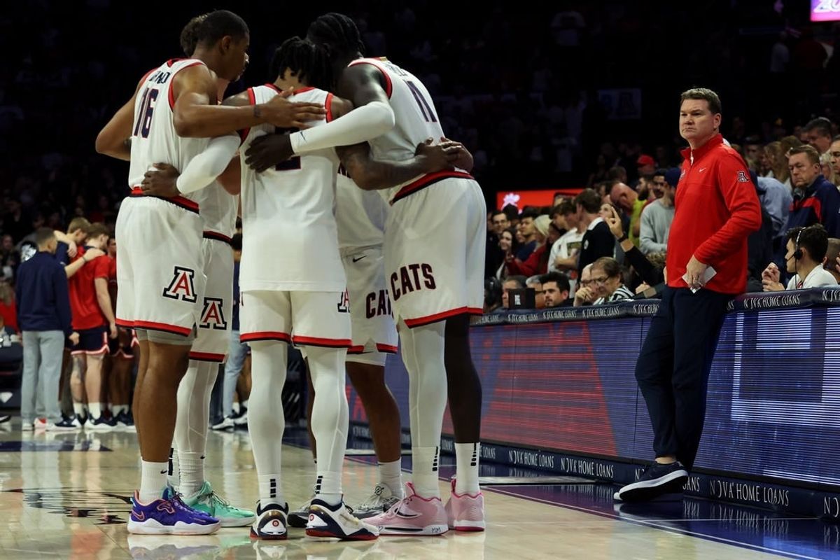 Nov 17, 2023; Tucson, Arizona, USA; Arizona Wildcats head coach Tommy Llyod on the sidelines as the Arizona Wildcats starting players huddle during the first half at McKale Center.