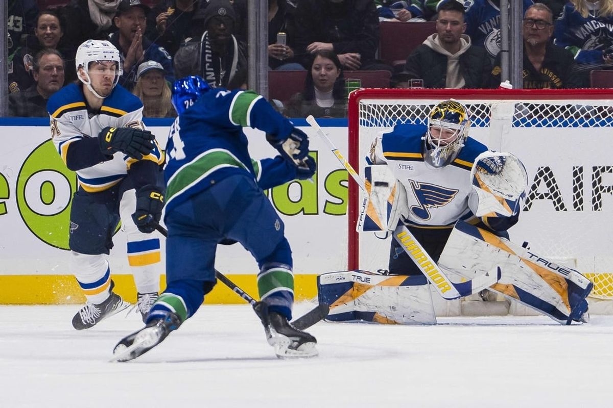Jan 24, 2024; Vancouver, British Columbia, CAN; St. Louis Blues goalie Joel Hofer (30) prepares to make as save on Vancouver Canucks forward Pius Suter (24) in the first period at Rogers Arena.