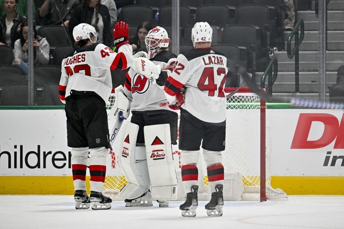 Mar 14, 2024; Dallas, Texas, USA; New Jersey Devils defenseman Luke Hughes (43) and center Curtis Lazar (42) and goaltender Jake Allen (34) celebrate on the ice after the Devils defeat the Dallas Stars at the American Airlines Center.