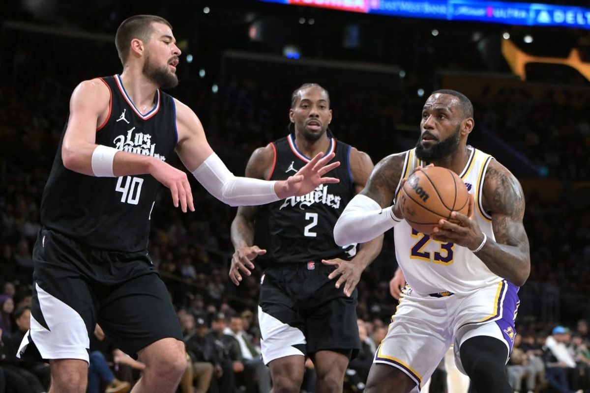 Jan 7, 2024; Los Angeles, California, USA; Los Angeles Lakers forward LeBron James (23) drives past Los Angeles Clippers center Ivica Zubac (40) and forward Kawhi Leonard (2) in the first half at Crypto.com Arena.
