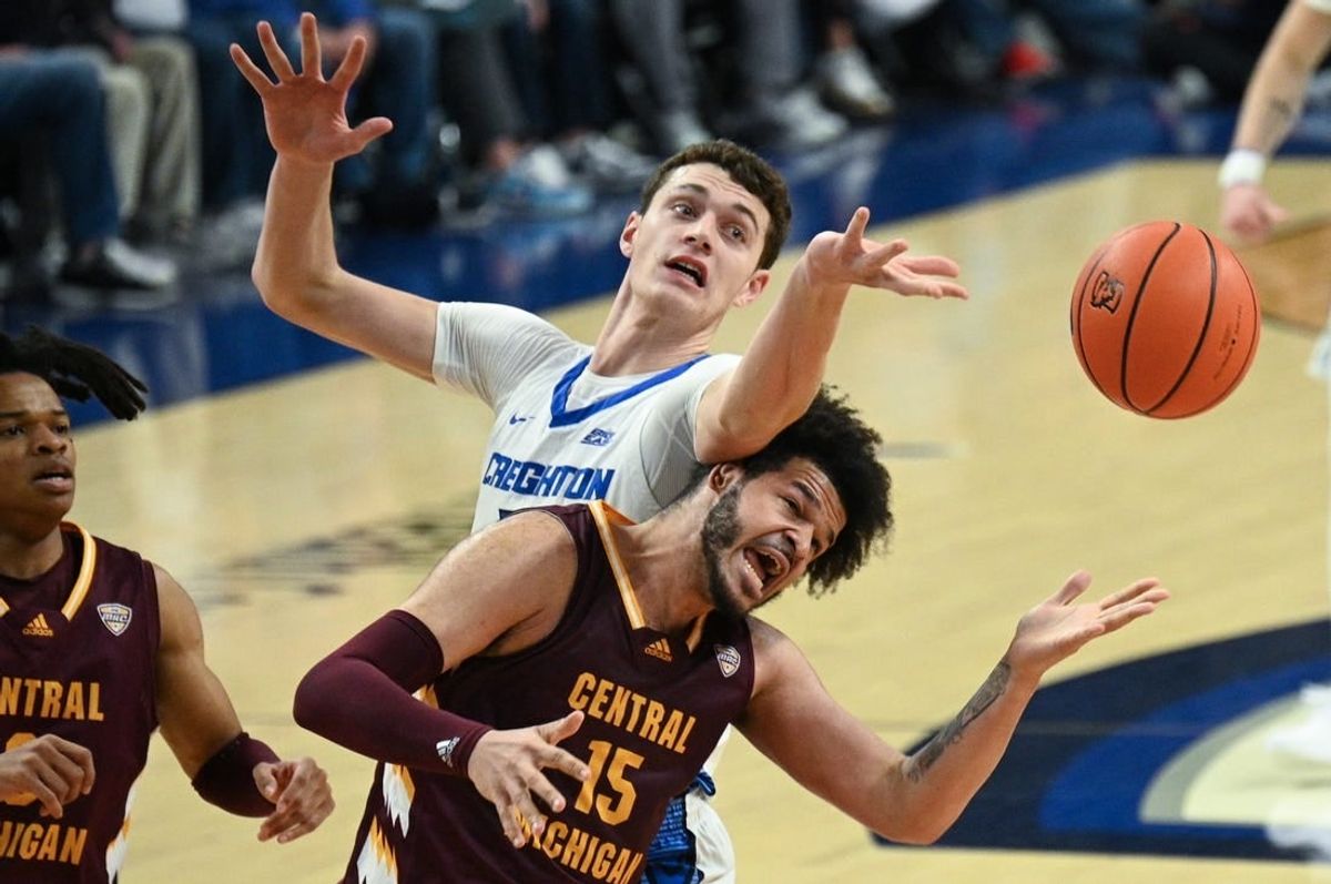 Dec 9, 2023; Omaha, Nebraska, USA;  Creighton Bluejays center Ryan Kalkbrenner (11) fouls Central Michigan Chippewas forward Markus Harding (15) on a rebound attempt in the first half at CHI Health Center Omaha.