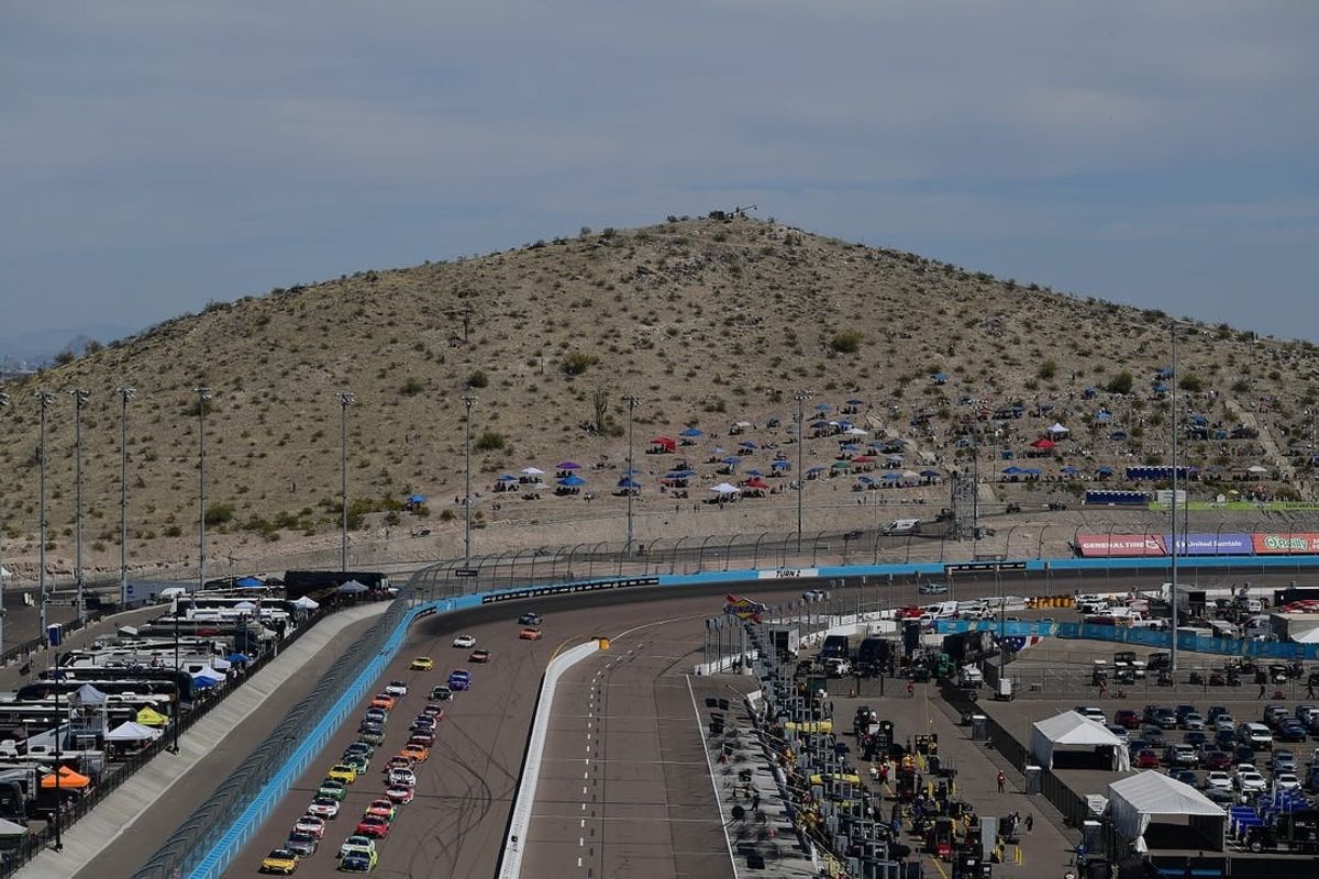 Mar 13, 2022; Avondale, Arizona, USA; General view as NASCAR Cup Series driver Kyle Busch (18) and driver Ryan Blaney (12) lead the field for the restart of the Ruoff Mortgage 500 at Phoenix Raceway.