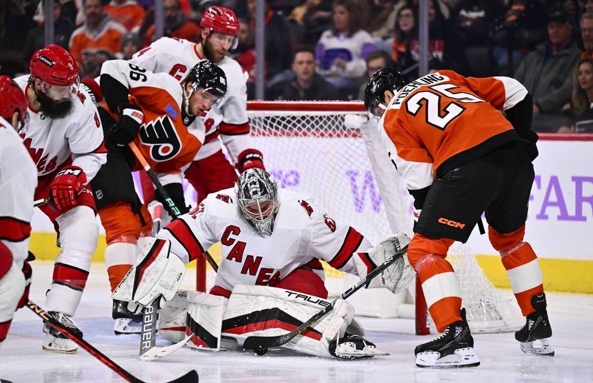 Nov 28, 2023; Philadelphia, Pennsylvania, USA; Carolina Hurricanes goalie Pyotr Kochetkov (52) makes a save against Philadelphia Flyers center Ryan Poehling (25) in the second period at Wells Fargo Center.
