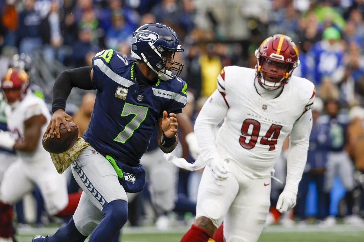 Nov 12, 2023; Seattle, Washington, USA; Seattle Seahawks quarterback Geno Smith (7) looks to pass against the Washington Commanders during the first quarter at Lumen Field.
